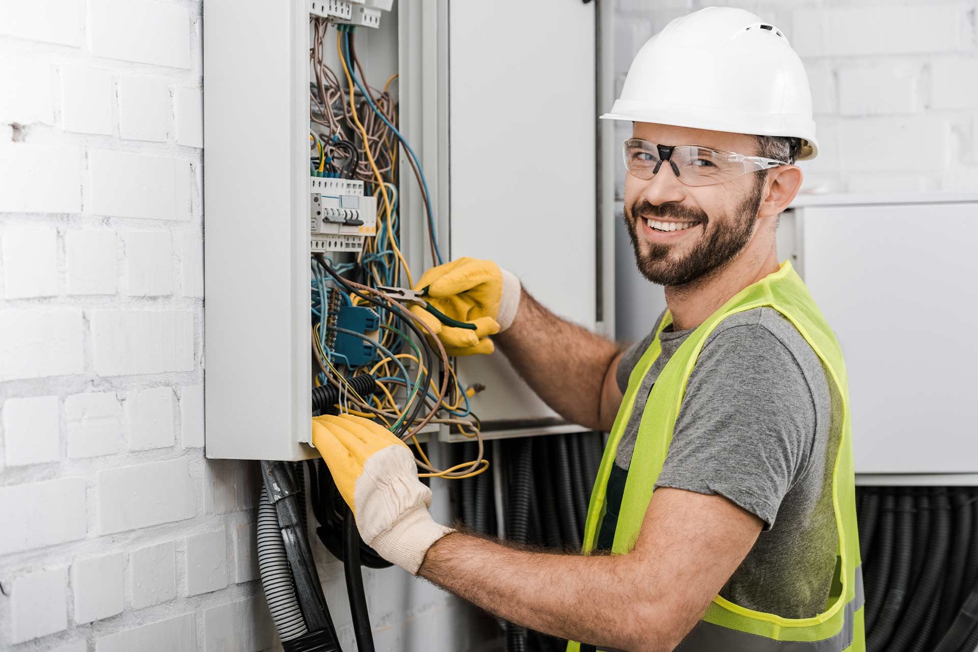 An electrician working at a fuse board